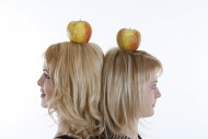 Two women with an apple on th...