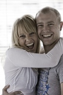 Young couple embracing, laughing