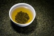 Green tea in tea bowl on dry ...