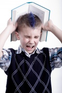 Stressed boy with a book