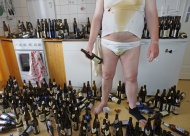 Scruffy man with empty beer b...