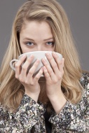 Young woman drinking hot tea