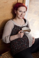Pregnant woman holding a cup ...