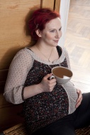 Pregnant woman holding a cup ...