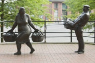 Sculptures of a fruit vendor ...
