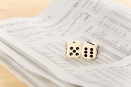 Two dice on a newspaper with ...