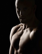 Bare-chested man, backlit