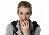 Young woman eating an apple