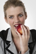 Young woman eating an apple