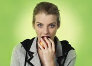 Young woman eating an apple