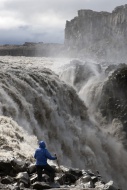Hiker at Dettifoss Waterfall,...