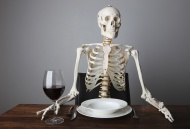 Skeleton sitting with a glass...