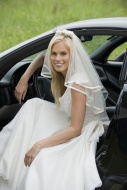 Bride sitting in a car, smili...