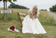 Bride sitting with head in ha...