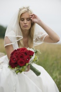 Bride sitting with bouquet, h...