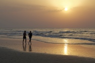 Two men jogging on the beach ...