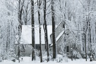 Snow falls outside a rural ho...