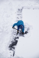 Adult shoveling snow after wi...