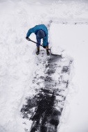 Adult shoveling snow after wi...