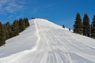 Empty ski slope under a blue ...