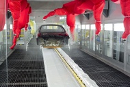 Robots paint a car body in th...