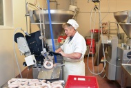 Woman working at sausage prod...