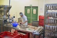 Woman working at sausage prod...