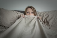 Young woman lying on her bed.