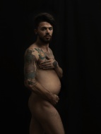 Naked pregnant man with tatoo...