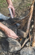 Man\'s hands lighting a fire ...