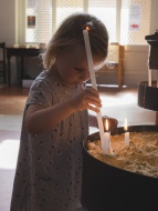 Little girl with candle in a ...