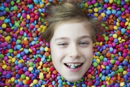 Boy bathing in chocolate buttons