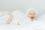 Laughing baby girl with cap l...