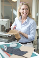 Smiling woman tailoring