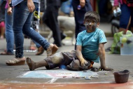 Peru, Lima, boy painting with...