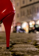 Red high heel on cobblestone ...