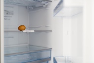 One brown egg in open fridge