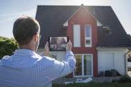 Man photographing his house w...