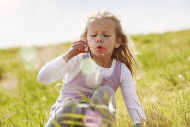 Portrait of little girl blowi...