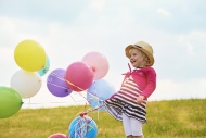 Little girl with balloons on ...