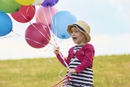 Little girl with balloons on ...