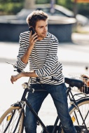 Young man with bicycle teleph...