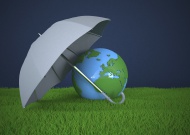 Globe with umbrella on green ...