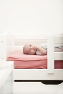 Portrait of baby lying on a cot