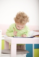 Little blond girl painting wi...