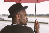 Young man holding umbrella