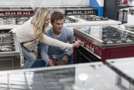 Young couple testing gas stov...