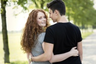 Teenage couple in love arm in...
