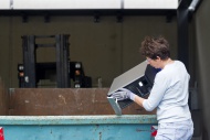 Woman at a waste container th...