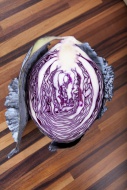 Half of a red cabbage on wood